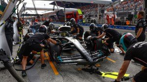 Members of the Mercedes-AMG Petronas team leap into action as Hamilton makes a pit stop during a practice session for the 2023 Dutch Grand Prix.