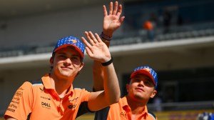 Oscar Piastri (left) and Lando Norris (right) greet the crowd during the drivers' parade prior to the 2023 United States Grand Prix.