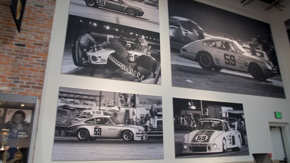 A wall of the Brumos Collection automotive museum with images of racing from Bill Warner.