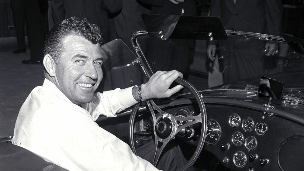 Carroll Shelby behind the wheel of a Shelby Cobra.