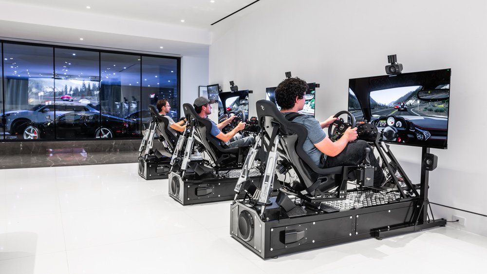 A look inside a Beverly Hills residence with three race simulators from CXC Simulations installed next to the owner's car collection.