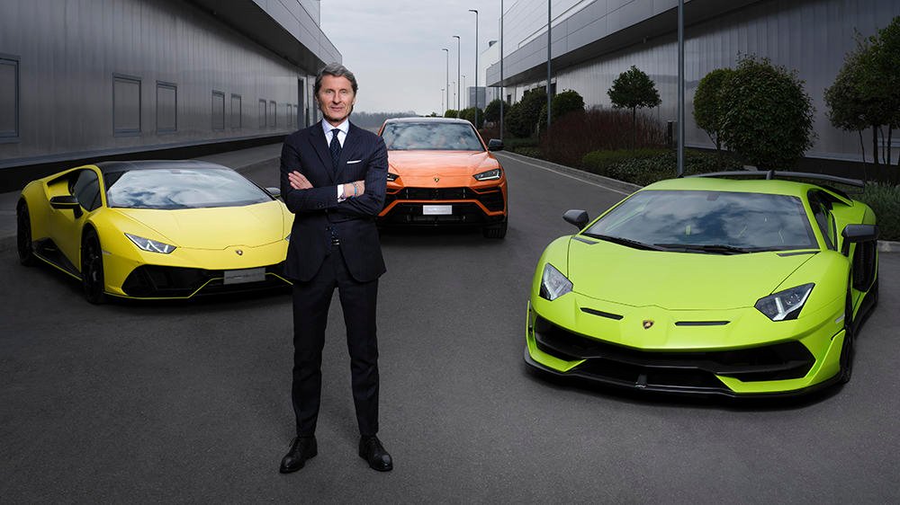 Lamborghini president and CEO Stephan Winkelmann in front of the Huracán, Urus and Aventador