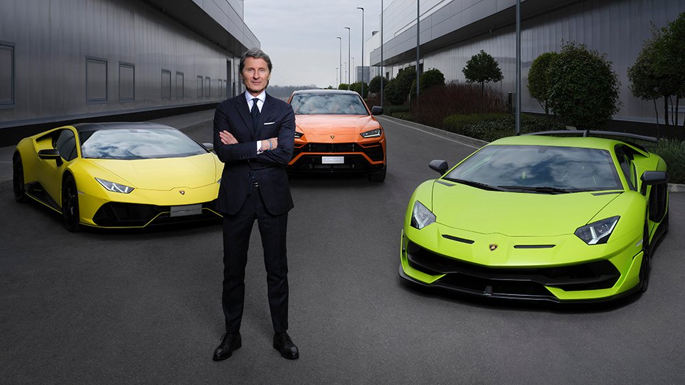Lamborghini president and CEO Stephan Winkelmann in front of the Huracán, Urus and Aventador