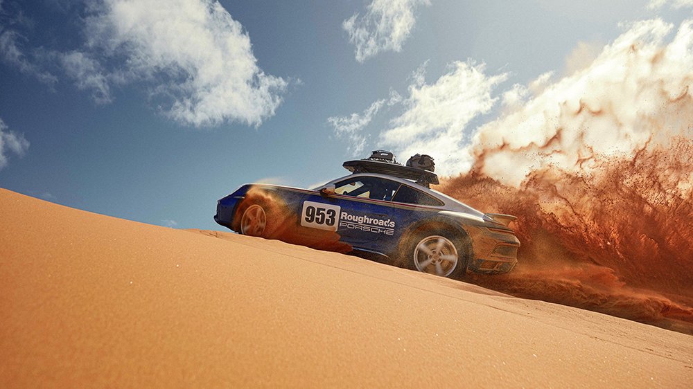 The 2023 Porsche 911 Dakar riding up a dune