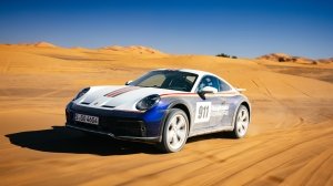 Porsche's 911 Dakar, in the optional Rallye Design Package trim, motoring through the Moroccan desert.