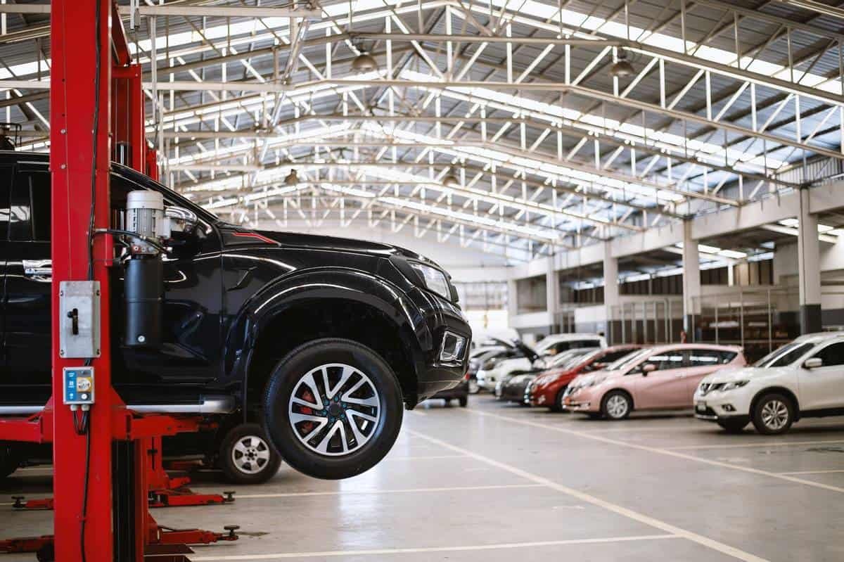 Car being serviced on a garage lift